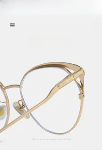 Detail view of gold metal glasses frame featuring vintage engraved temples and light structure