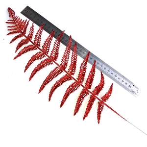 Detailed view of red glitter fern leaf decoration showing 30cm scale and texture