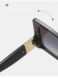 Close-up of durable golden metal hinge on black oversized bow-tie style sunglasses