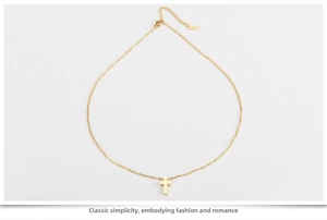 Close-up of rose gold cross necklace detail featuring K18 stamp on adjustable clasp