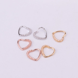Detailed view of heart-shaped hoop earrings in gold, silver, and rose gold with zircon inlay