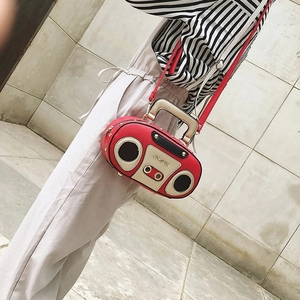 Vintage radio-shaped crossbody bag in red and beige faux leather on model