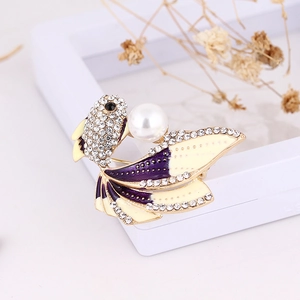 Detailed close-up of goldfish brooch featuring white pearls and colorful enamel fins