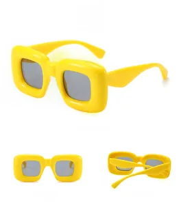 Three-view display of thick yellow square Y2K sunglasses with grey lenses and chunky frame