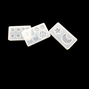 Detailed translucent silicone molds featuring star, moon, and cat paw shapes for DIY resin