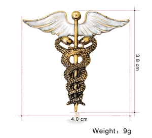 Detailed size view of a 3.8x4cm golden metal caduceus brooch with white enamel wings