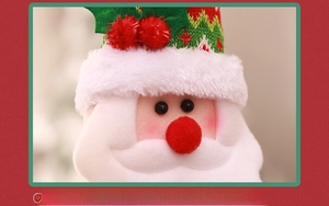 Close-up of plush Santa Claus holiday computer cover with 3D knitting and sewing details