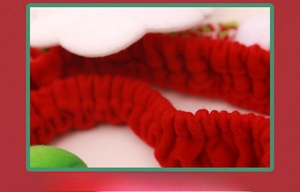 Detail of red elastic band on Christmas monitor cover with soft velvet texture