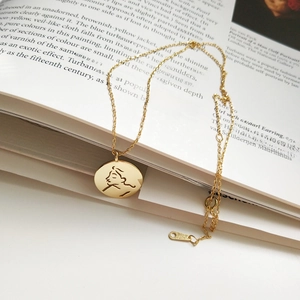 Detail view of 925 sterling silver S925 hallmark on minimalist face pendant gold necklace