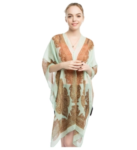 Detail of mint green paisley chiffon shawl with breathable semi-transparent fabric texture