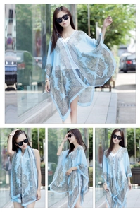 Close-up of light blue paisley chiffon sun protection shawl with button detail