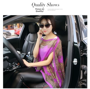 Detail of purple paisley chiffon shawl with ethnic pattern worn for sun protection
