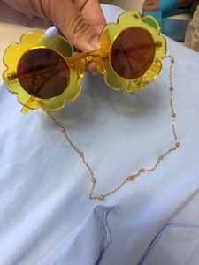 Detail of yellow flower sunglasses frame and golden bead eyewear chain for fashion