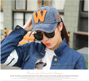 Blue washed denim baseball cap with orange W embroidery and vintage side badge detail