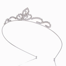 Close-up of silver crown headband featuring intricate rhinestone heart and leaf designs