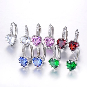 Detailed view of heart-shaped multi-color gemstone earrings with micro-pave zircon settings
