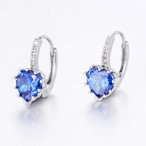 Close-up of heart-shaped blue zircon earrings with sparkling pavé cubic zirconia