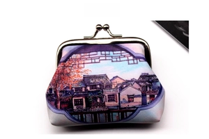 Close-up of vintage town scenery print on a coin purse with retro metal clasp closure