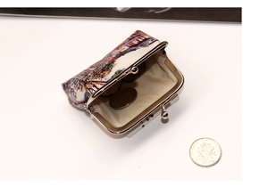 Detail view of vintage oil painting printed coin purse with classic metal kiss lock closure