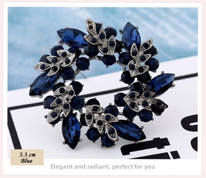 Detail view of a 5.3cm blue crystal flower brooch with marquise-cut rhinestones
