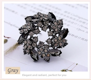 Detail of a gray Bauhinia crystal brooch with dark marquise stones on a vintage base