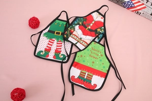 Detail of mini Christmas apron wine bottle covers with Santa's Little Helper theme design
