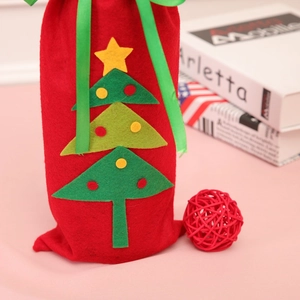 Detail of red felt Christmas wine bag with green tree applique and silk ribbon