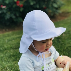Detail of white breathable baby sun hat with wide brim and neck flap for UV protection