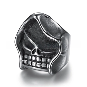Detail of vintage silver skull ring with punk style oxidation and intricate bone textures