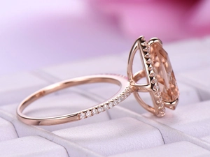 Luxury rose gold ring with large oval champagne gemstone and halo diamond settings