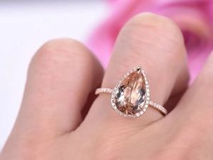 Luxury rose gold ring with pear-cut morganite gemstone and sparkling halo diamonds