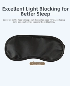 Close-up of black sleep mask featuring a light-blocking nose design and silk fabric