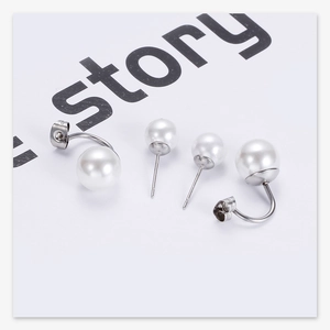Detail view of 10mm double pearl stud earrings in stainless steel and silver finish