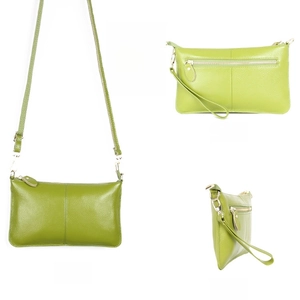 Detailed view of a green pebble leather envelope bag with gold zippers and detachable straps