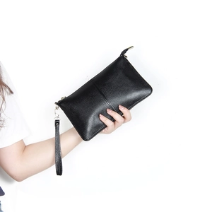 Minimalist black pebble leather envelope clutch with wristlet and crossbody strap