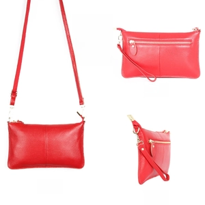 Detailed views of red lychee grain leather envelope bag with gold zipper and straps