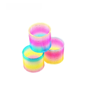 Close-up of rainbow gradient spring toys with sparkling glitter and vibrant colors