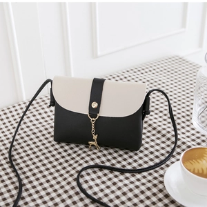 Mini crossbody bag in black and cream PU leather with gold deer pendant and thin strap