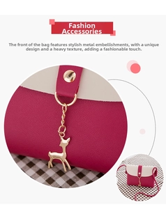Detail of elegant gold deer pendant and luxury leather stitching on mini crossbody bag