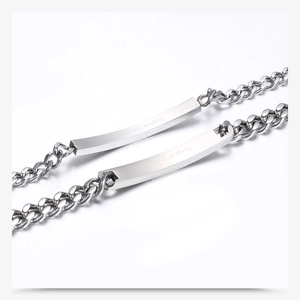 Detail of surgical stainless steel curved bar on a classic cuban chain bracelet for couples