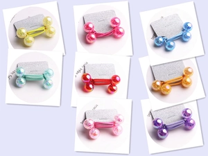 Detail of colorful double-ball hair ties with glitter resin effect in grid layout