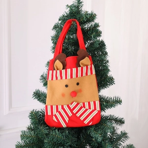 Christmas reindeer felt gift bag with red nose hanging on a decorated festive tree