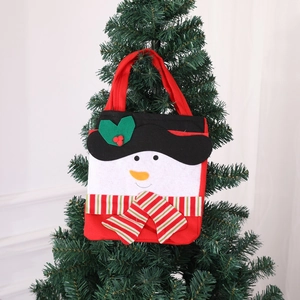 Christmas snowman gift bag made of non-woven fabric hanging on a festive Xmas tree