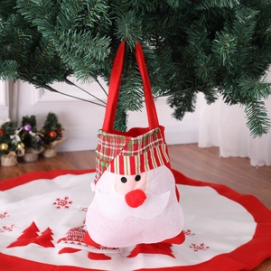 Close-up of Santa Claus gift bag with red plaid details by a festive Christmas tree