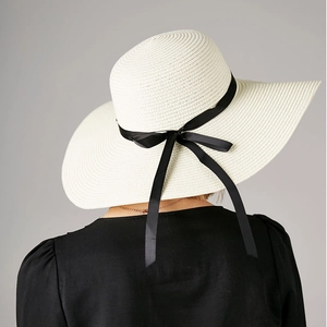 Elegant wide-brim straw sun hat in cream with black satin ribbon and bow for women
