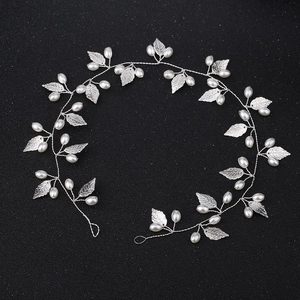 Elegant silver bridal hair vine with metallic leaves and white faux pearls for wedding styling