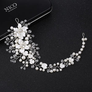 Macro shot of silver bridal hair vine featuring handcrafted resin flowers and pearls