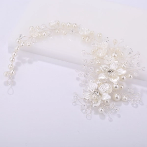 Handmade bridal hairpiece with ceramic flowers, pearls, and crystals on silver wire