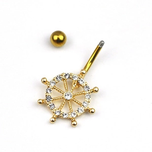 Detailed view of a golden nautical helm navel ring inlaid with sparkling crystals