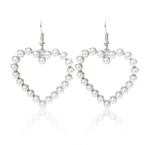 Elegant hollow heart-shaped pearl drop earrings with silver metal hooks on white surface